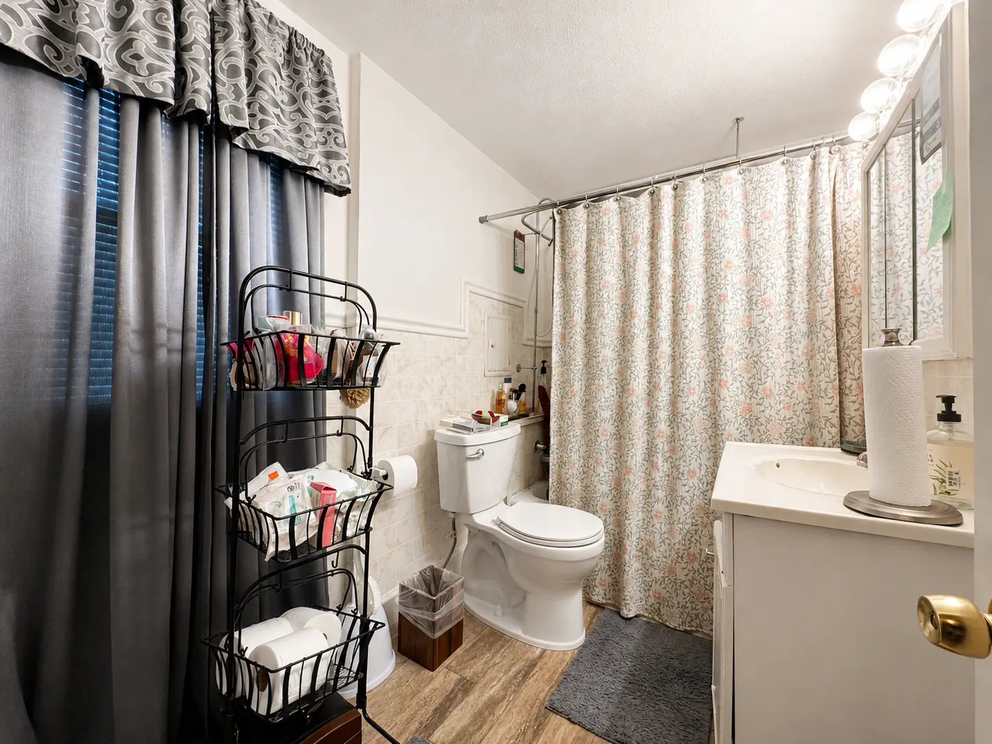 Full bath at 3718 Revere Drive with a tub and shower, tile surround, and vanity