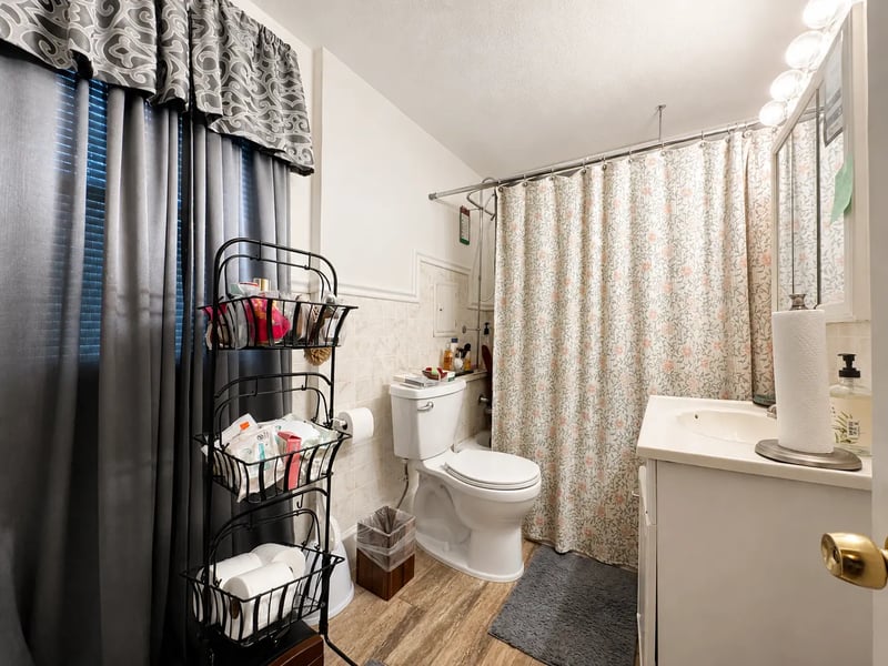 Full bath at 3718 Revere Drive with a tub and shower, tile surround, and vanity
