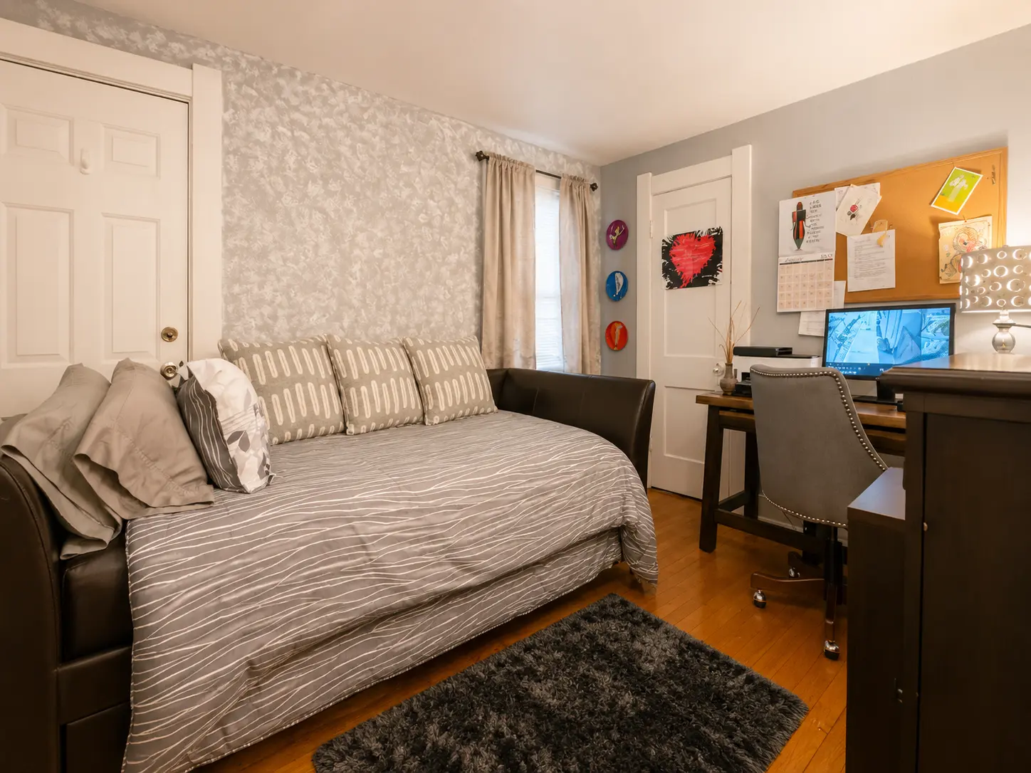 Bedroom at 3718 Revere Drive with hardwood floors, a daybed, and a desk workspace