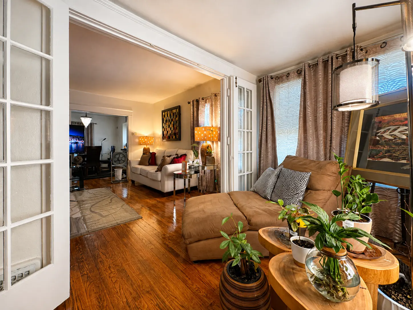 Sunroom at 3718 Revere Drive with French doors opening into the living room and hardwood floors