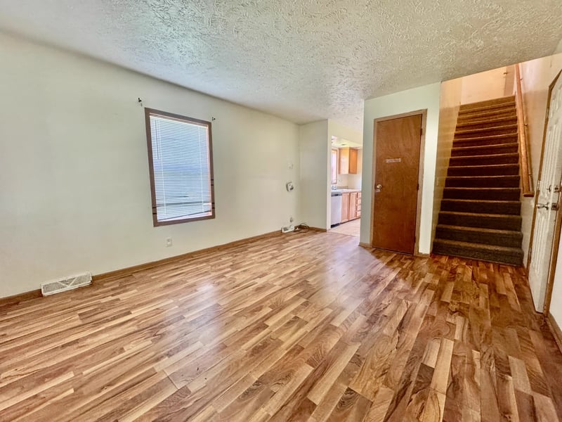 Living room with laminate flooring and staircase