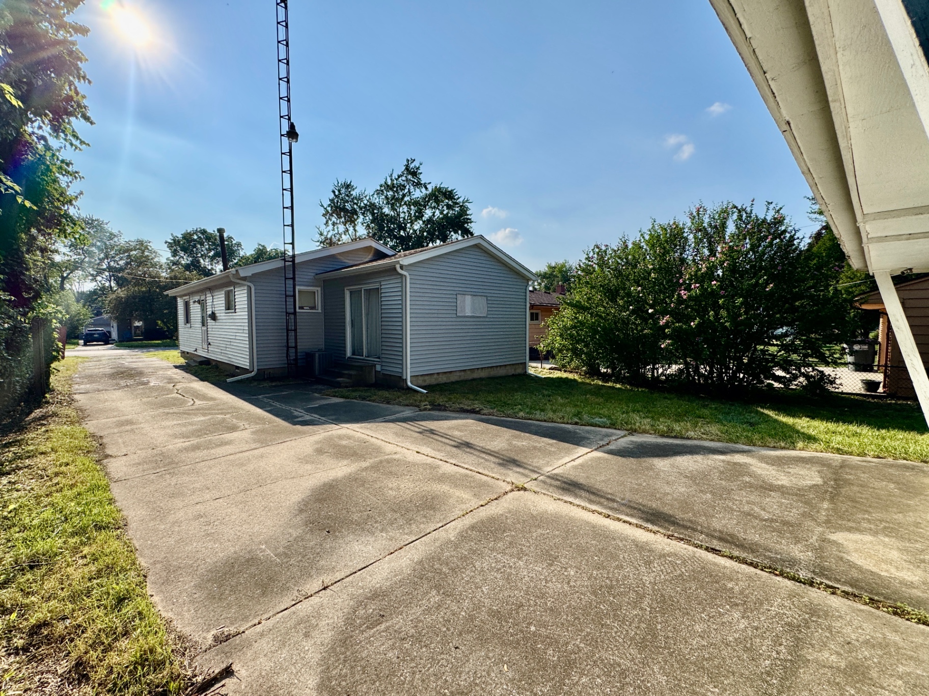 Rear and side exterior showing the driveway approach to the home
