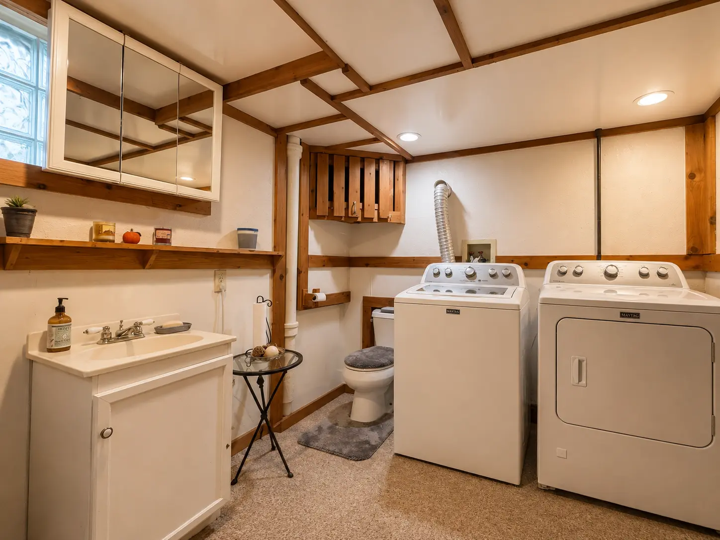 Basement laundry area at 3718 Revere Drive with washer, dryer, sink vanity, and second full bath fixtures