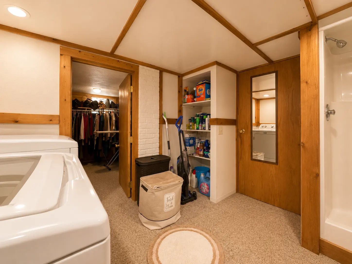 Basement laundry room at 3718 Revere Drive looking into the walk-in closet and shower area
