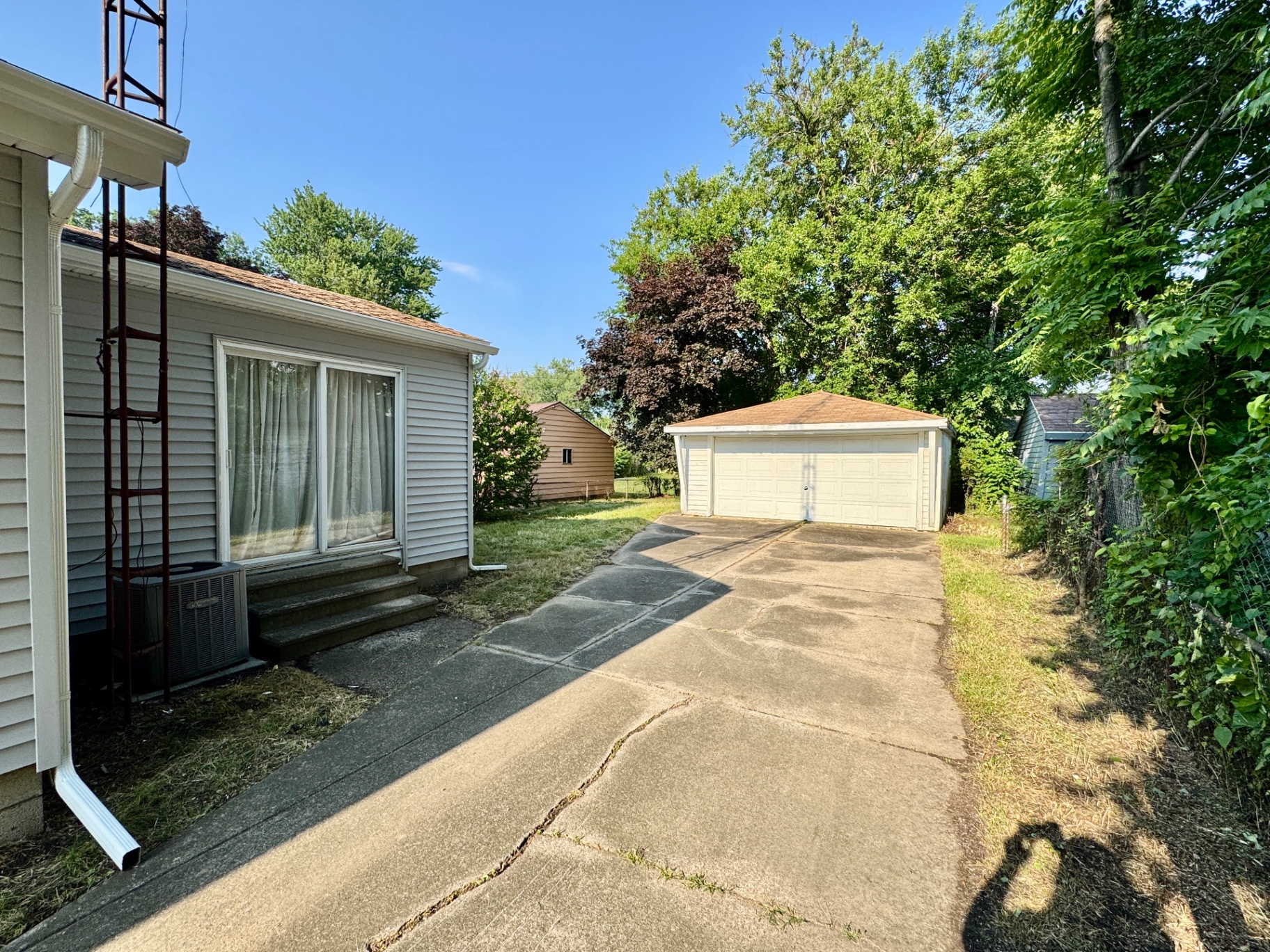 Long driveway leading to the detached two-car garage