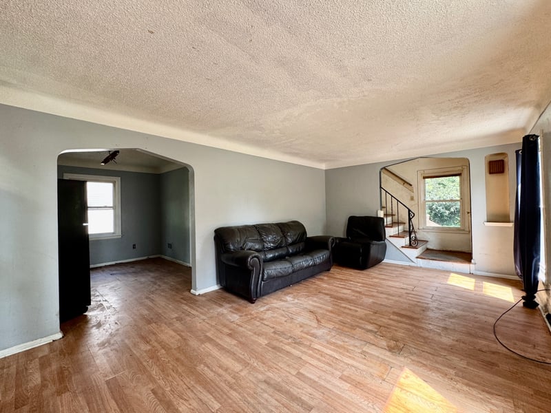Wide living room at 510 Richards Road with hardwood floors and staircase