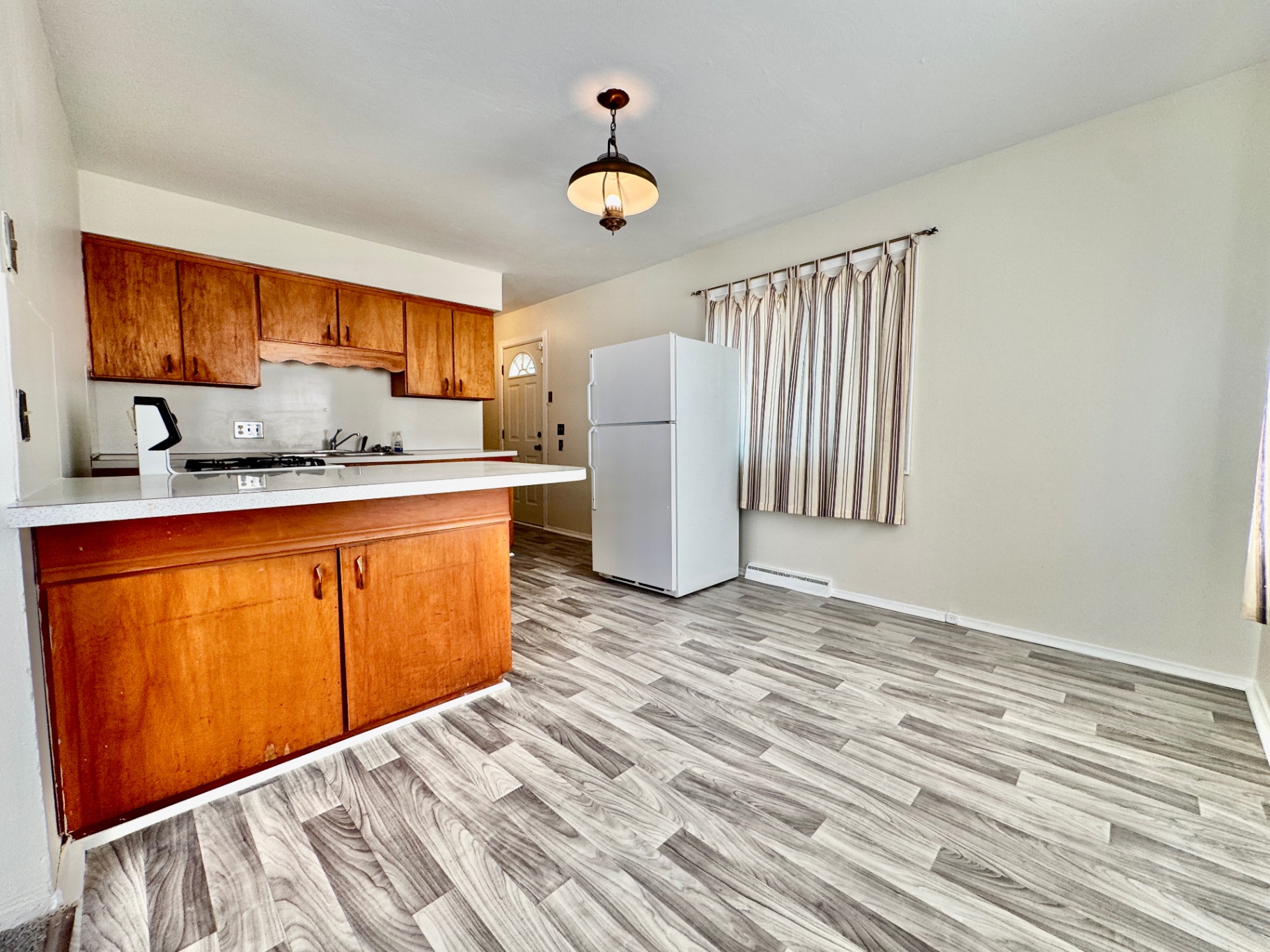 Kitchen and dining area with breakfast bar and updated flooring