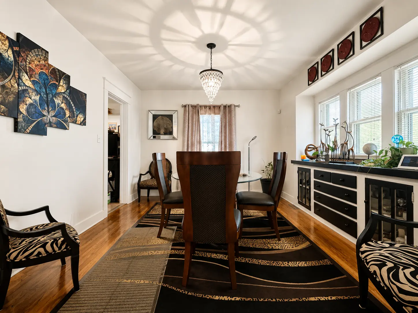Dining room at 3718 Revere Drive with a crystal chandelier, built-in buffet, and bay window