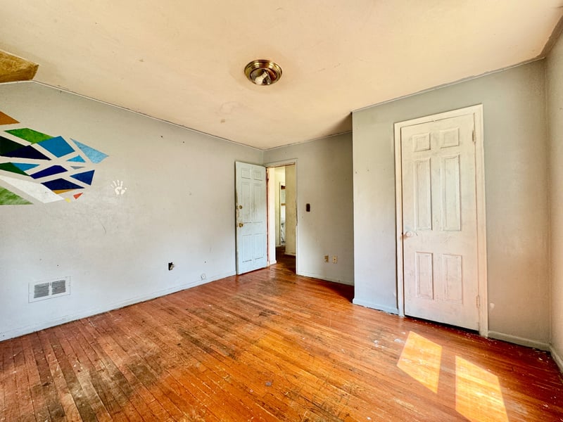 Bedroom at 510 Richards Road with hardwood floors and geometric wall accent