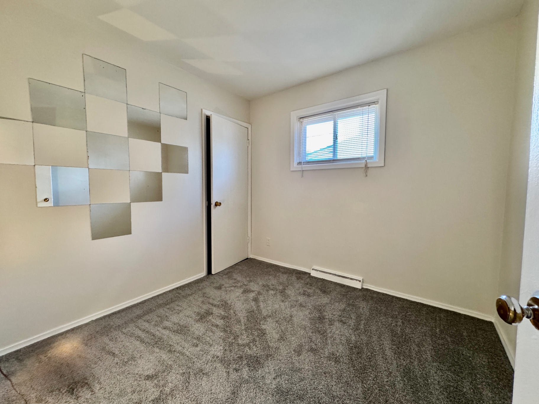 Bedroom two with fresh carpet and simple layout