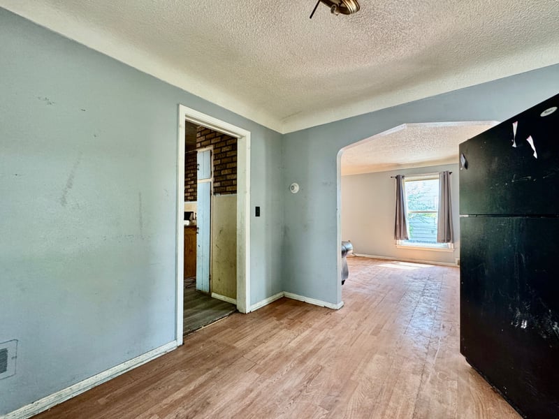 Dining area at 510 Richards Road with arched openings to the kitchen and living room