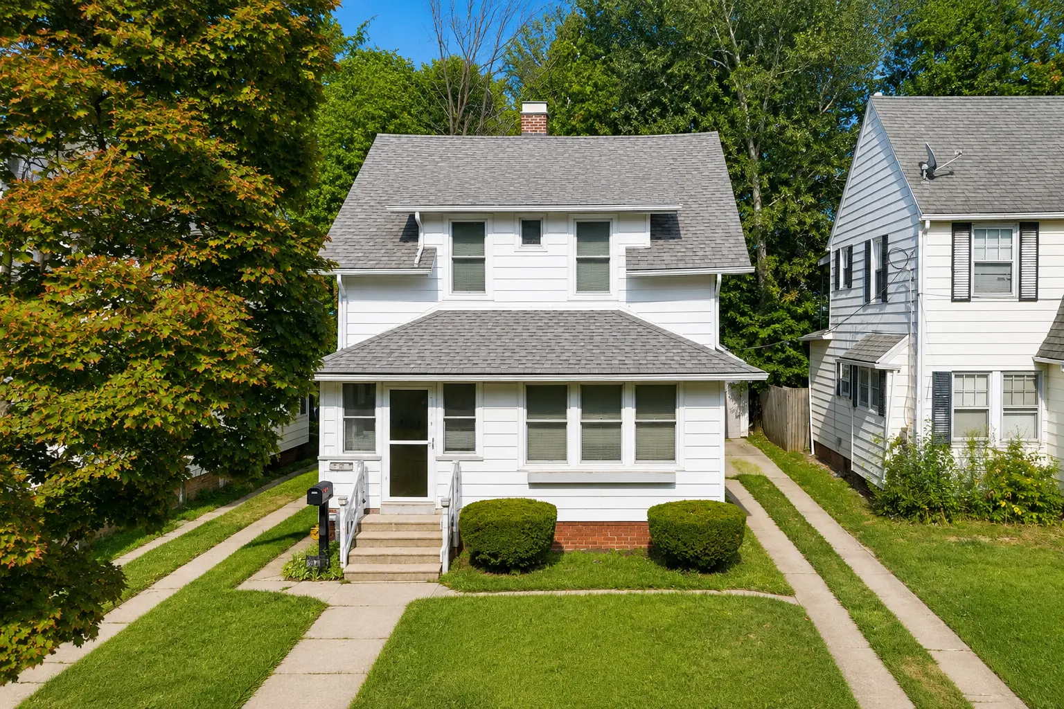 Straight-on front elevation of 3718 Revere Drive showing the porch, walkway, and landscaped front yard