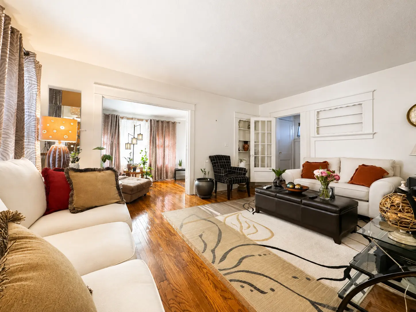 Living room at 3718 Revere Drive looking toward the sunroom and built-in cabinetry with French doors