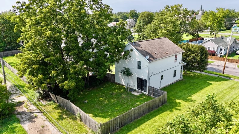 Aerial view of the home and fenced rear yard