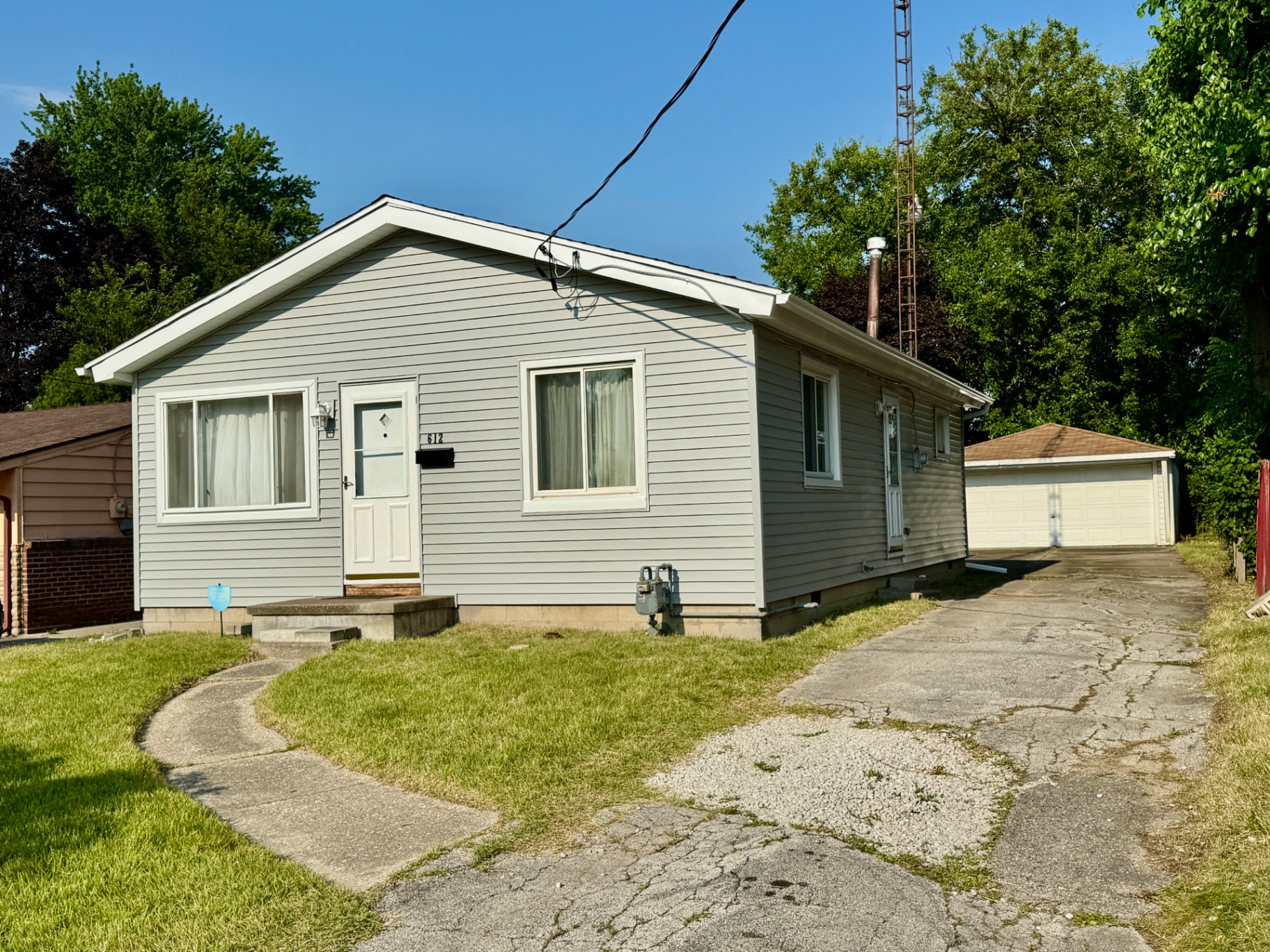 Front exterior view of 612 Underwood Avenue with driveway and detached garage