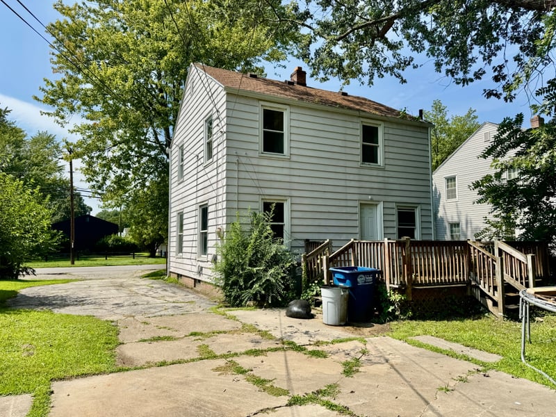 Rear exterior of 510 Richards Road showing the back entrance and deck