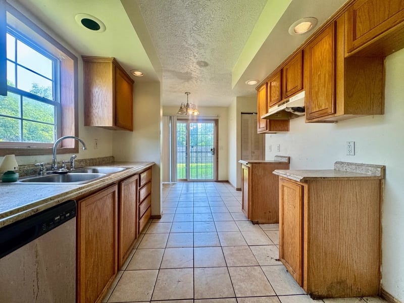 Galley kitchen with wood cabinetry